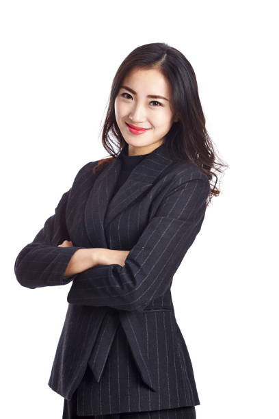 studio portrait of a young asian businesswoman in formal wear, arms crossed, isolated on white background.
